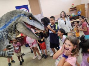 kids interacting with a dinosaur